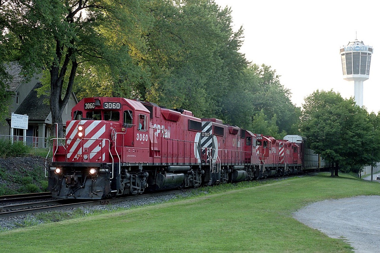 Just another day in what was my personal paradise back then.  CP coming over from the States, rumbling thru the NF tourist district and then past me at the South Siding Switch Montrose on its way to Toronto. The sun is setting, and you can see indications of that on the left high up in the trees. Lighting was often very tricky in town.
With the removal of the track thru the city in the early 2000s, this location is now just a switch back for the Chippawa local to access industry in the area. Just as well. In the continual desire to rake in more money, the city of Niagara Falls has imposed "No Stopping" on the open pull-off area here. Heaven forbid somebody should be able to park anywhere for free !!!
Power on this train is CP 3060, 3090, 8205 and 8243. First two units still on CP roster, second pair are not.