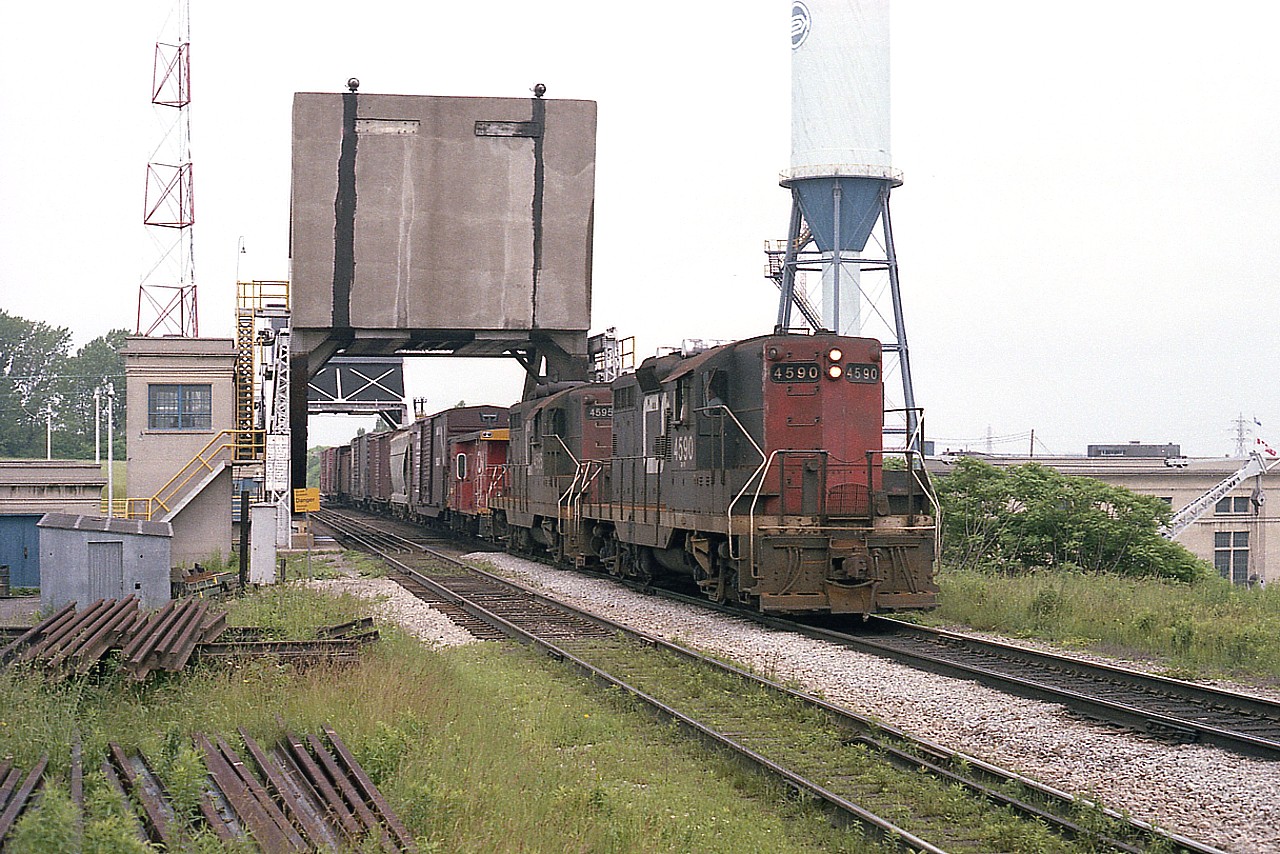 The east side of bridge 6 by the Welland Canal is a seldom utilized location for photos because of its' rather awkward accessibility.  But in years past, there was a gravel road open to the public and I took advantage of it.  In this view, the daily local with CN 4590 and 4595, complete with transfer van, works along the line. I assume this is based at Niagara Falls yard, with power maintained at Fort Erie.