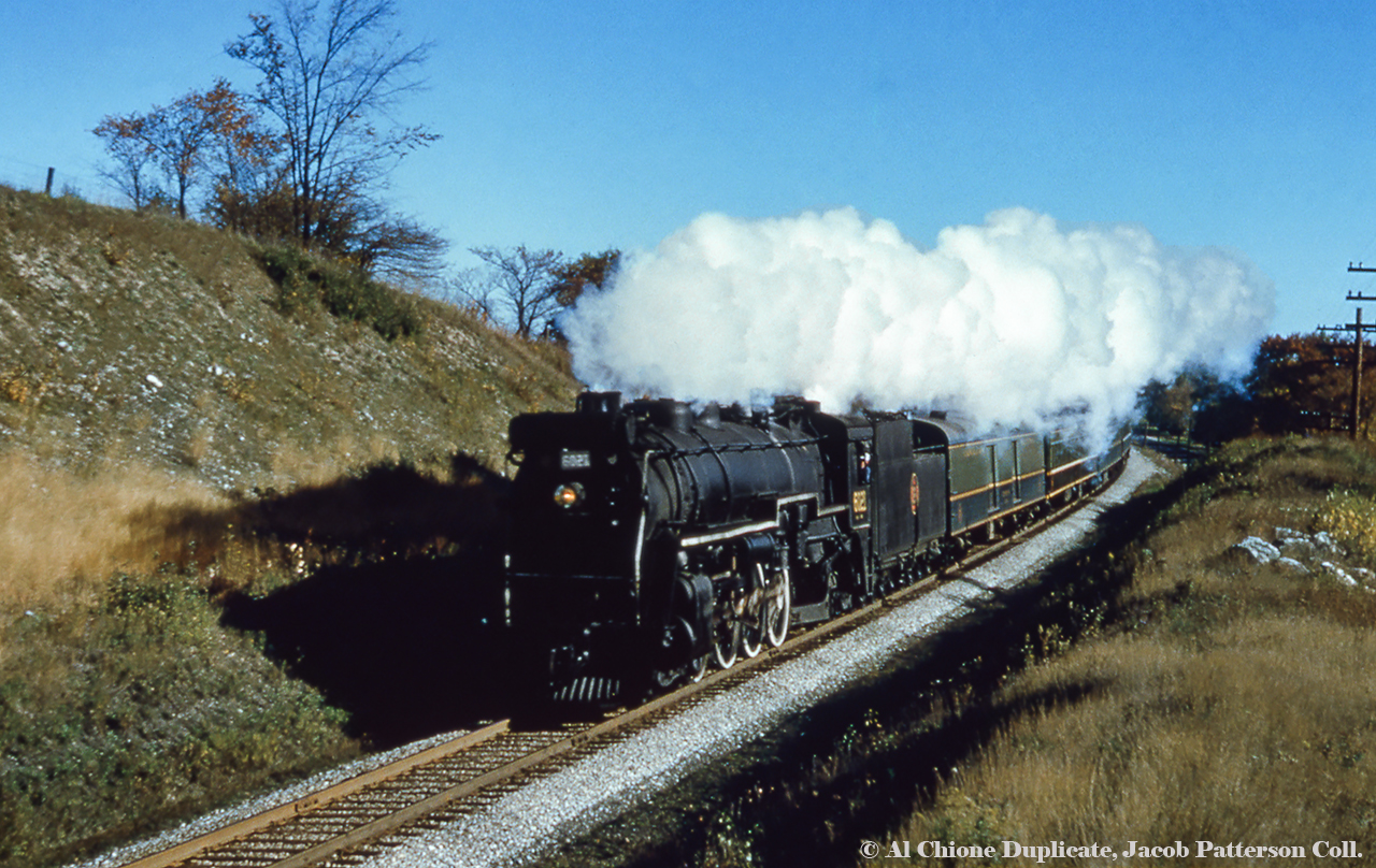 Cityview Drive Part 1 - Westbound: Daily except Sunday train 29 (Toronto - London) swings around the curve approaching Guelph about to cross Cityview Drive.  Located on a blind curve, Cityview was closed in the early 2000s.  U-1-b Mountain 6021, built by CLC in June 1924, would be scrapped in March 1960.Part 2 - Eastbound found here.Original Photographer Unknown, Al Chione Duplicate, Jacob Patterson Collection.