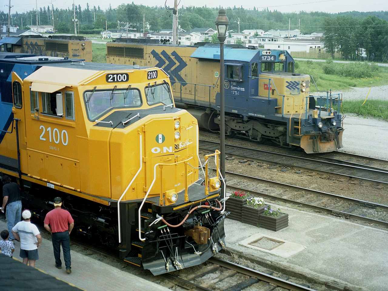 Very convenient location for a photo is out on the roof of the Cochrane station/Hotel and the company had newly minted ONR 2100, the first SD75I for the road making the rounds for management and employees to have a first hand inspection. The unit had been on display the day before at Englehart. Seemed like a good idea to follow the engine to it's next Open House at Cochrane.
ONR SD40-2s #1734 and 1733 are seen in background, making up a train. Yes, the SD75I, first of 6 acquired, ushered in a new era in locomotives for the ONR, but as luck would have it, the 2100 was wrecked in an accident December 4, 2011; while the old SDs continue to soldier on.