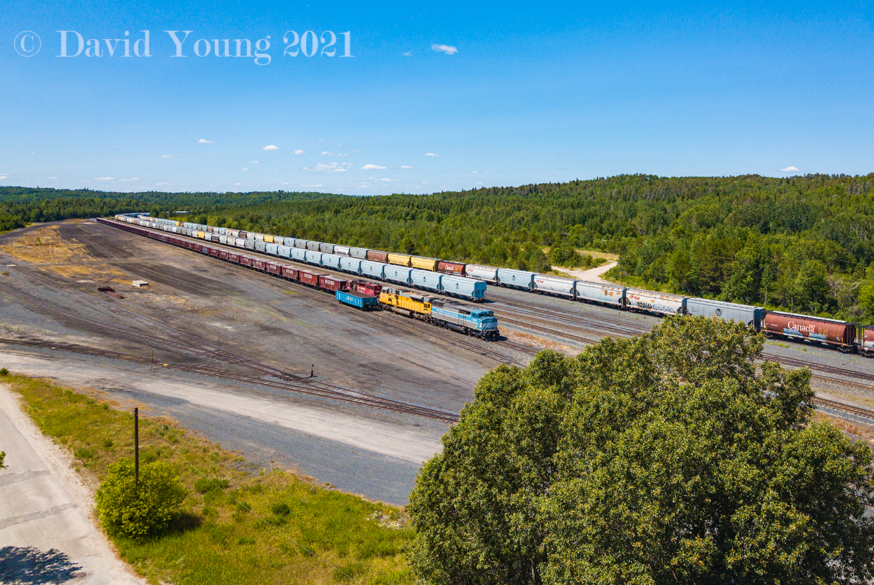 Ignace Yard. Just a shell of it's former self. It's main job these days can see the loading and unloading of supplies for ES (ties, tie plates, anchors, etc), car storage and to facilitate the rock trains which come and go from Dyment Pit 37 miles to the west. So I suppose this picture sums it's purpose up perfectly. A "Box Train" (grain empties) has been yarded in the north yard, while in the south yard a solo gondola loaded with ties sits beside a Herzog train fresh in from "The Pit", having been yarded in track 1 and showcasing the eclectic GMD trio of CP 9014- CP 3649- CP 5866.

Of note, you may notice the white haze on the horizon. That is smoke from the reported 76 fires that were burning across the district, within 3 weeks that number would sky rocket to over 120 fires. This year has been incredibly dry across most of western and central Canada and into the northwest region of Ontario. Prayers to all those affected by the fires.