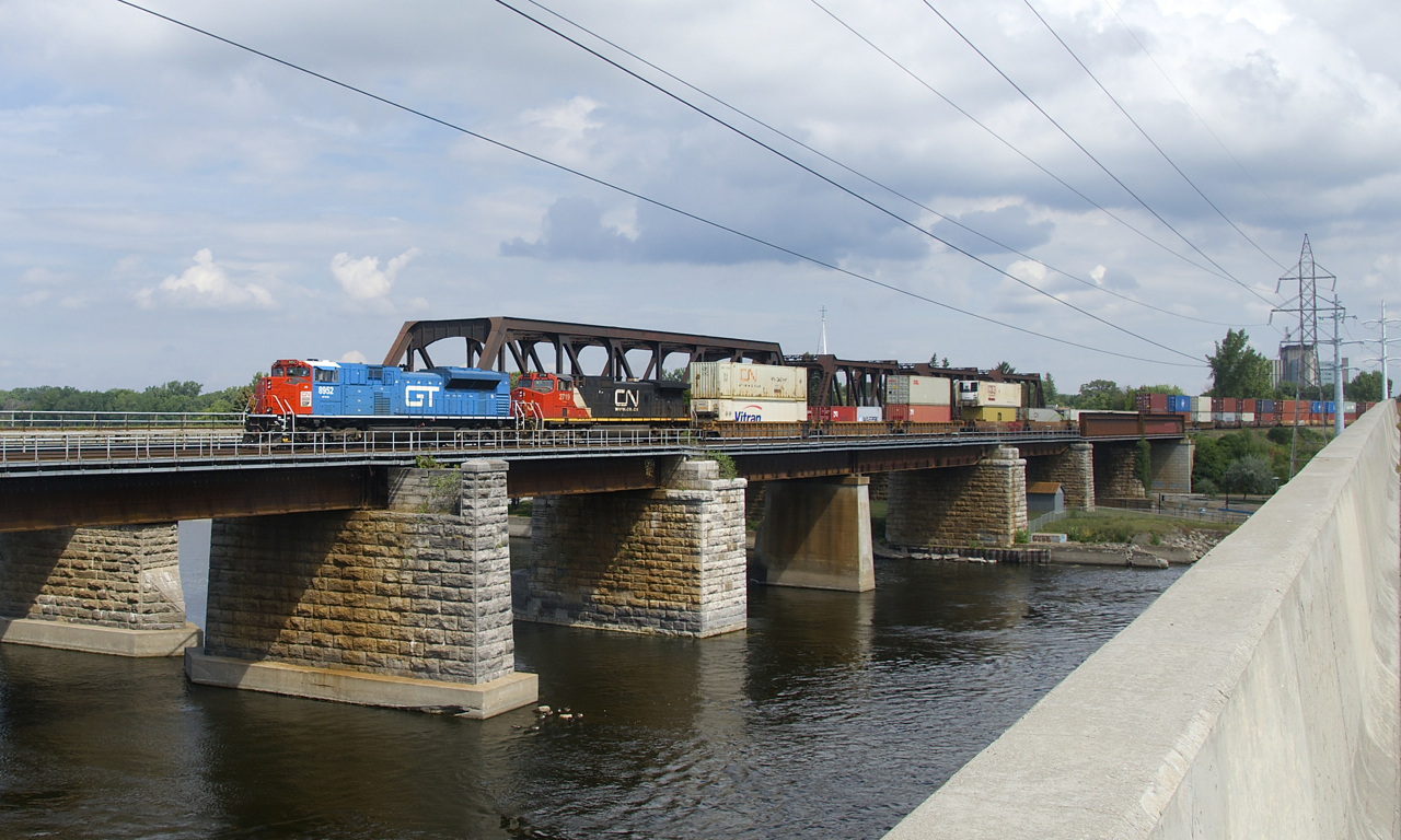 A later than usual CN 185 is leaving the island of Montreal as it approaches Île-Perrot with heritage unit CN 8952 leading and IC 2719 trailing.