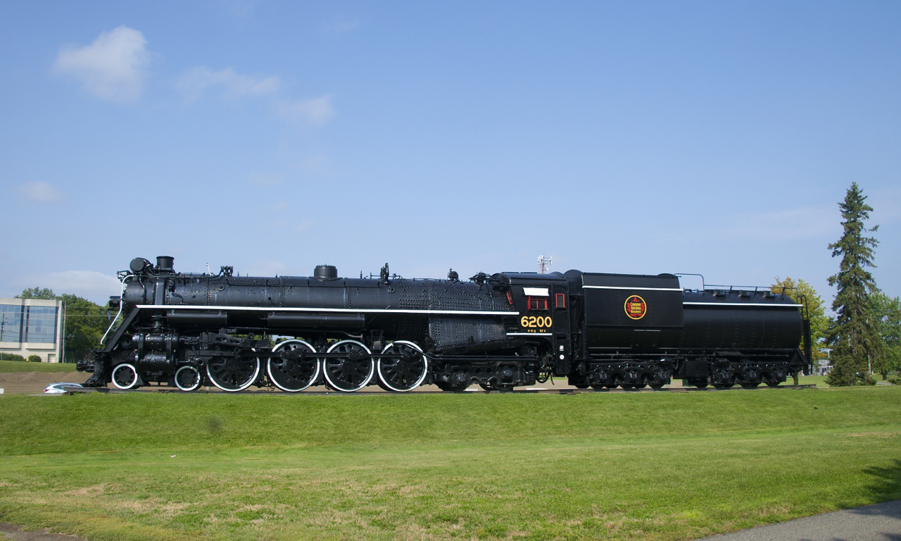 A broadside view of CN 6200 on a sunny morning. It has 73 inch drivers and a Vandberbilt tender. Underneath the cab window is '57%,' representing a tractive effort of nearly 57,000 pounds (56,785 to be exact).