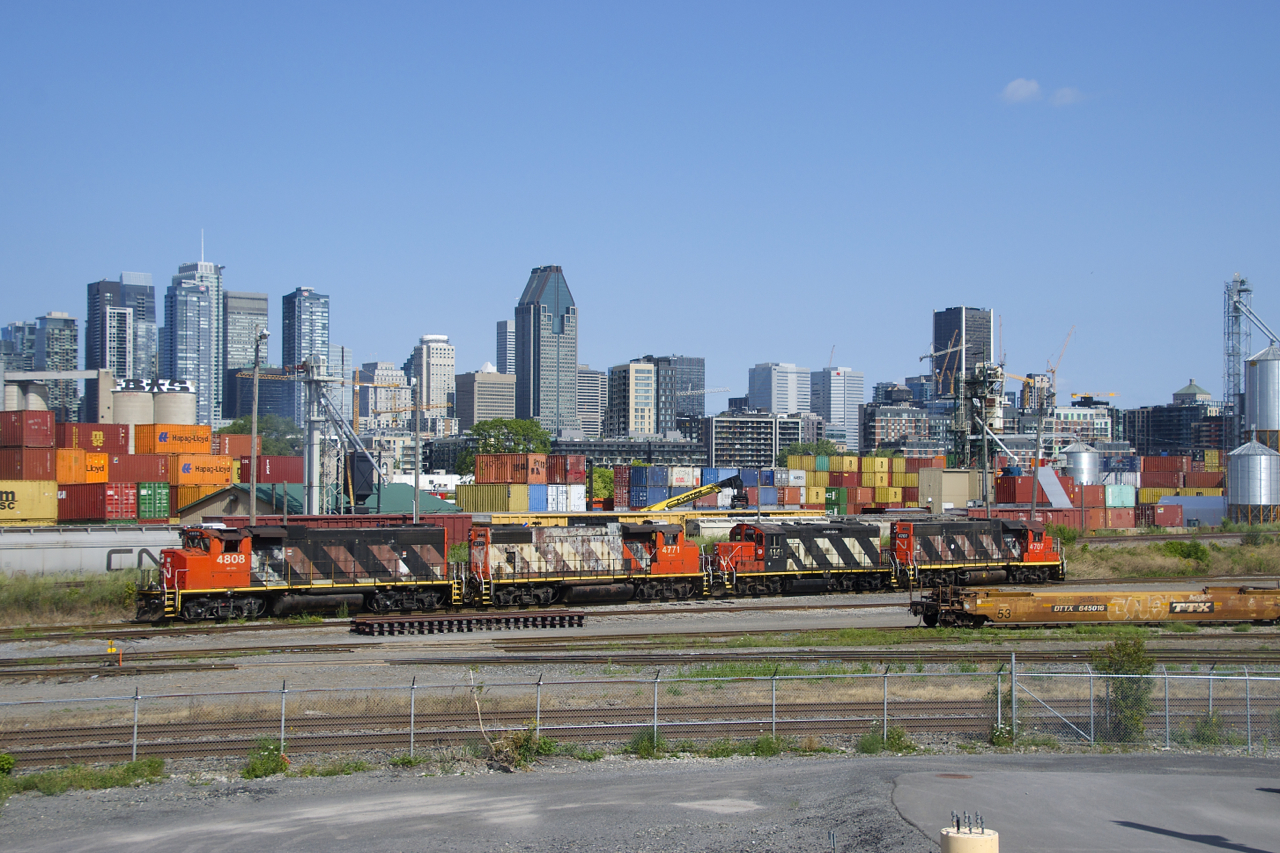 A quartet of zebra striped geeps (CN 4808, CN 4771, CN 4141 & CN 4707) is heading to the shop track to grab a caboose (shoving platform at this point) before taking grain cars to tracks PC-10 & PC-27.