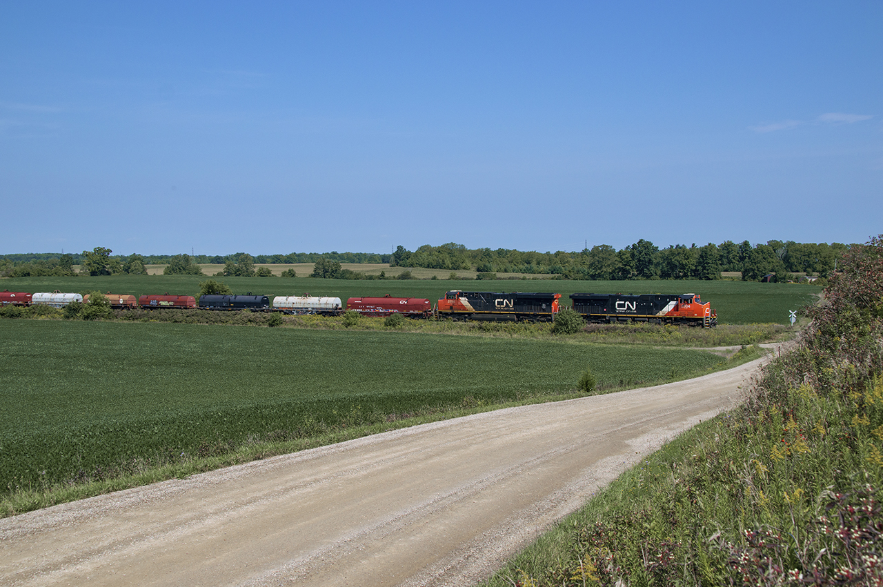 With 90 cars on the drawbar, L502 makes it's trek down the Hagersville Sub under a 10mph slow order due to the ongoing heat wave.  After clearing the Dundas Sub main at Brantford, 502 would wait for over half an hour to get a clearance from the RTC, and allow a foreman to get his TOP and patrol the track ahead.  Here the train is seen dawdling up to Middleport Road en route to Garnet, but it will make a stop at Hagersville to set off 10 cars on account of Garnet yard being full.