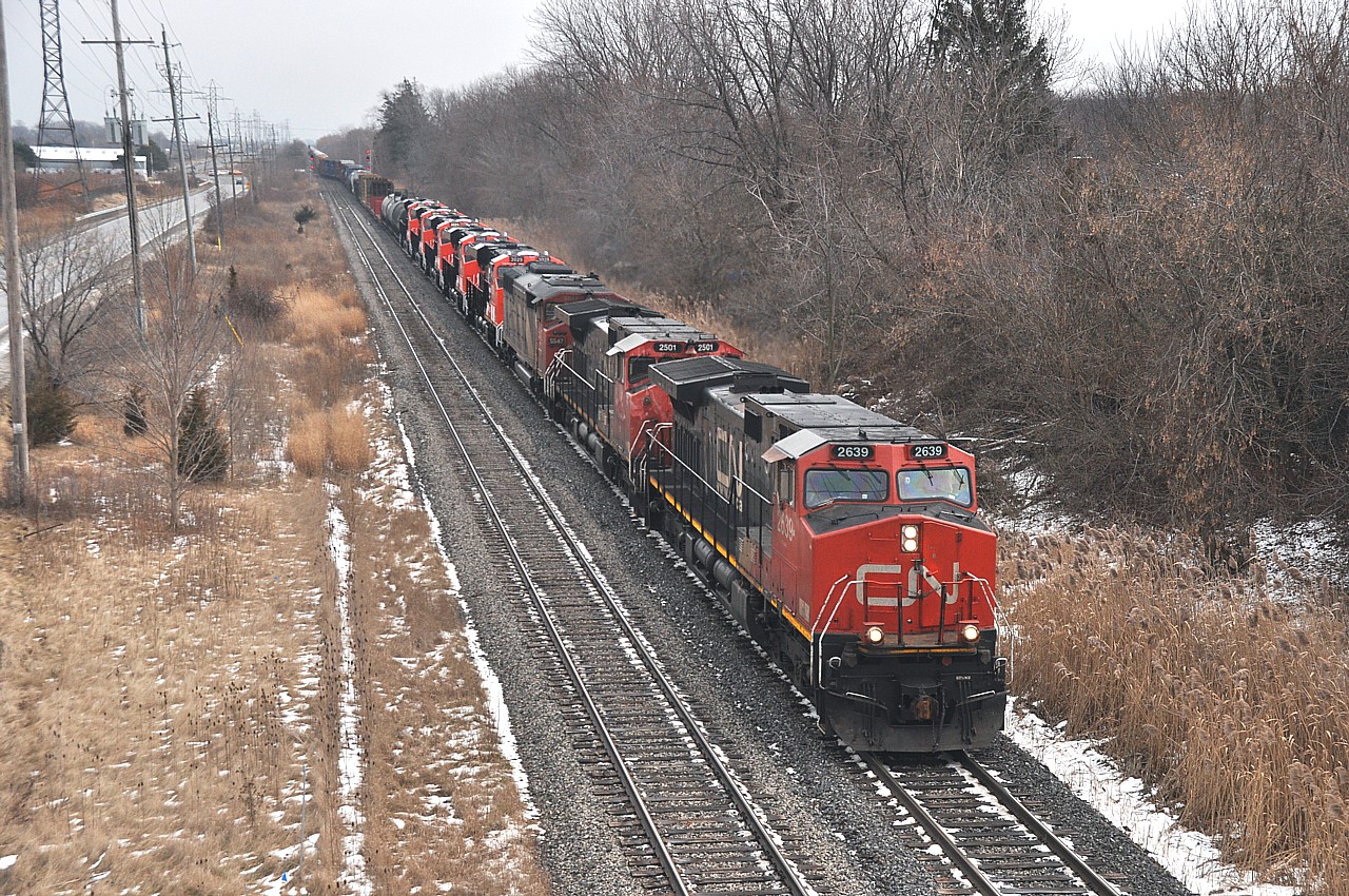 The CN ET44AC big GEs.  I'm tired of them. Even in 2015 it took a bit to get me to rustle myself out into the cold to bother with these. Bitter wind on the Maple Av bridge in Grimsby gave me second thoughts about shooting these new arrivals after already catching them in Merritton. But, what the heck. I persevered. Power is CN 2639, 2501, 5547, 3029, 3028, 3025, 3026 and 3027.