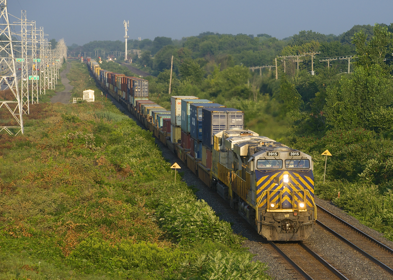 CN 108 has a pair of ex-Citirail units (CN 3915 & CN 3929) as it heads east into the sunrise just after passing CN 149. CN has acquired a number of Citirail units that had been numbered in the CREX 1300 and 1400-series; my understanding is they will be getting 75 of these units in total.
