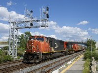 CN 731 has CN 5701, CN 2672 and 177 empty potash cars at it passes under a relatively new signal gantry in Dorval.