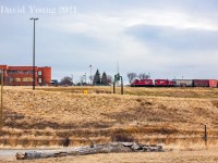 High above the Deerfoot Trail, a CP job with GP9u's 1647 and 1567 complete with an old van, is beginning their descent to the mainline past the Calgary Herald, having completed their days task along this industrial trackage known as the M Lead, which branches off the Red Deer Sub at Zoo. It is quite the dip down to the mainline... That's the top of the codeline in the foreground! <br><br> <i>On a side note, I found my self checking out recent satellite and street view images of the area and this trackage seems to be unused and abandoned. Time marches on...</i>