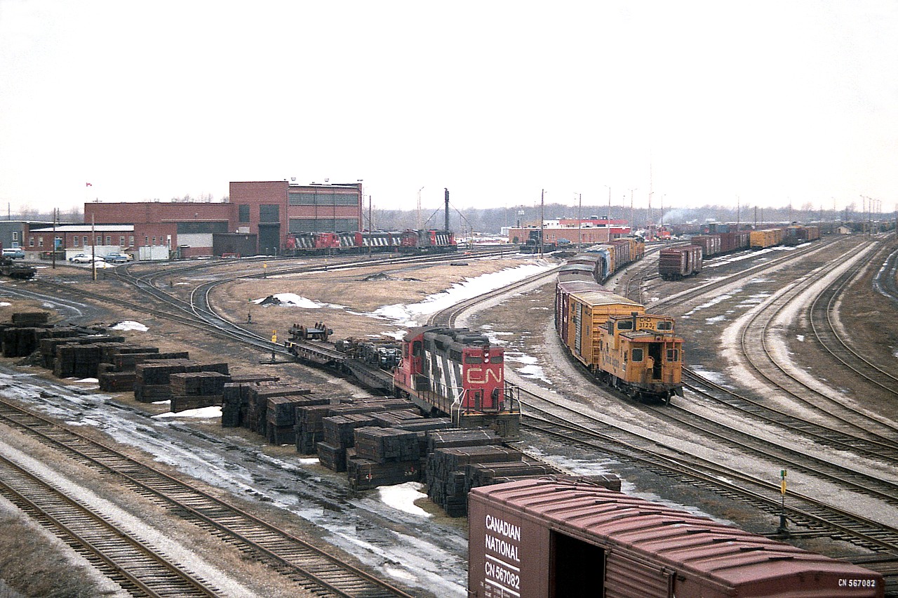 This is an example of the activity at Fort Erie yard back in the day when I used to drop by. Talk about busy!! All kinds of activity to keep someone and their camera busy. FAs, FBs, GP9s, SD40s; heck, whatever your fancy, it was around somewhere. Of note an enormous stack of new ties down on the bottom left by the old line to the Dunnville sub; as well as the arrival of the Chessie transfer, led by 3533 and 4350. Always something going on.