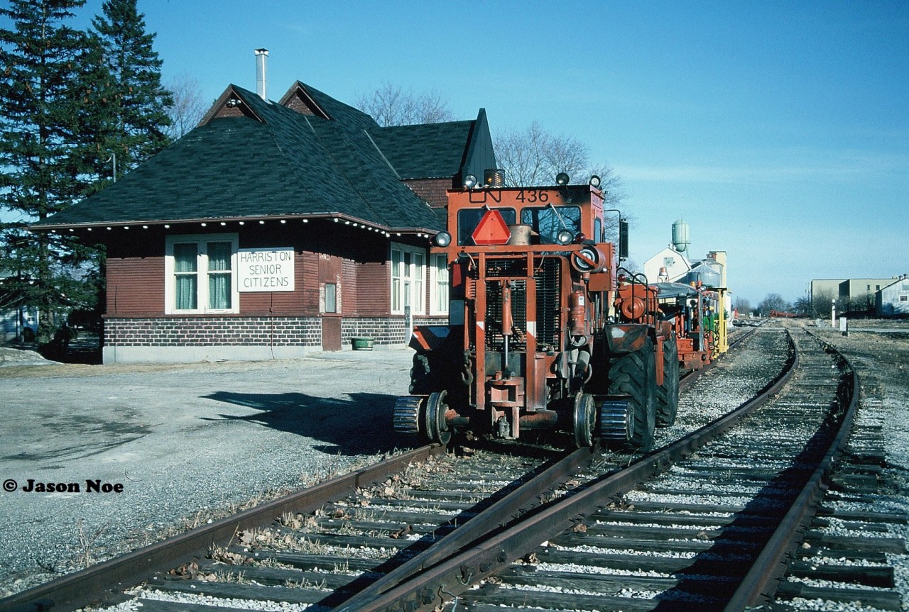The former CN Harriston station gets a front row seat to what was become the following day as track machinery is viewed already staged as the CN rail salvage train can be seen tied-down for the night in the distance. These track machines would slowly follow the rail salvage train as it removed the Owen Sound Subdivision from Harriston to Listowel collecting the remains of the line once the rails were pulled.