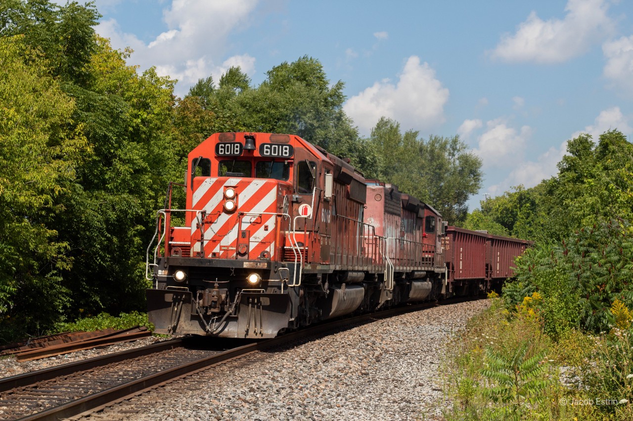 A Southbound Herzog Ballast train lead by CP 6018 & 5743 seen at the Oak Street crossing in Weston.