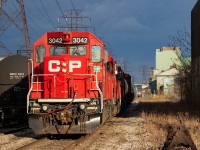 I recently posted <a href="http://www.railpictures.ca/?attachment_id=46440" target="_blank">a shot of CP TH21 westbound at Depew Street</a> in Hamilton on the CP Beach Branch, and now offer a view of a CP TH21 westbound at Depew Street on the CN N&NW Spur. Same crossing, different tracks and view. In this particular instance, they are shoving back onto their own rails after pulling ahead on the N&NW Spur to pull the interchange. 