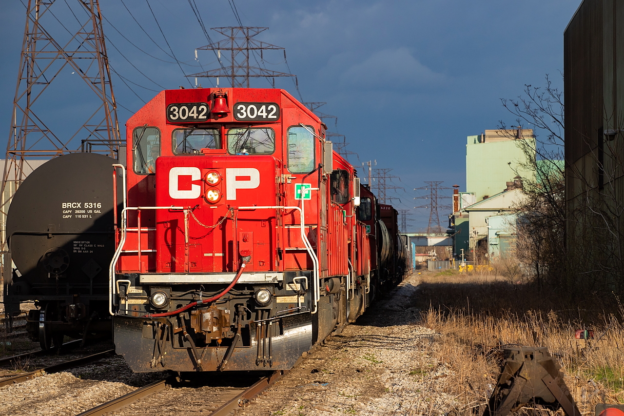 I recently posted a shot of CP TH21 westbound at Depew Street in Hamilton on the CP Beach Branch, and now offer a view of a CP TH21 westbound at Depew Street on the CN N&NW Spur. Same crossing, different tracks and view. In this particular instance, they are shoving back onto their own rails after pulling ahead on the N&NW Spur to pull the interchange.
