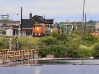 Hearst turn sits in front of the station ready to depart for Hearst after exchanging trains with the turn from Cochrane. The dam on the Kapuskasing River supplies water for the Spruce Falls Paper Co. the towns major industry. This was part of the National Transcontinental  Quebec Winnipeg main, later CN