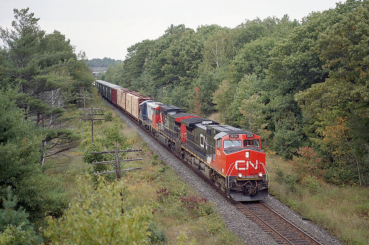 After seeing a bit of commentary below Mr. Host's "freezing cold" but gorgeous image of that plough train at Stratford and the 4001 in consist; I thought I would dig up a photo of when that unit first arrived in Ontario. Just a photo for those who follow the GEXR, here is Lakeland & Waterways #4001 as third unit behind CN 2634 and 2517 on a Toronto-bound manifest train as seen from an overpass just north of Parry Sound.
Lakeland & Waterways was taken over by CN in 2006 after having been a RailLink line since 1997.