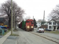 This scene is but a memory as the line is now gone. Trillium 108 is photographed rumbling along the middle of Townline Rd in Welland. For this line, a long train, complete with their rather poor looking caboose on the end. I shot this at distance for a good view of the neighbourhood. Old reliable MLW S-13u began life as CN 8617 way back in 1978, and it is still rolling.  Remarkable, really.
