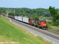 On a sweltering hot day the crew of L551 have all the doors open to ensure both man and machine do not overheat as they head into Hamilton with Michael DaCosta as conductor.<br><br>
<a href=http://www.railpictures.ca/?attachment_id=43700 target=_blank>I posted about this hill in a prior photo</a>but fans of Bayview from afar might not recognize this location - this is the 'new' hill I talked about that was created after the triple tracking project completed into Hamilton. This nice vantage point was basically a dirt mound for years as the project continued, but in 2020 was seeded to grass making it official. This is the result, while only a handful of freights pass this spot, it's going to be a nice spot to get Amtrak, VIA and GO in the future as well, so as long as it does not grow in too much (it will, eventually). There were three of us on the hill and I was the only one crazy enough to not have a cold beverage in hand, it was a hot hot hot day.