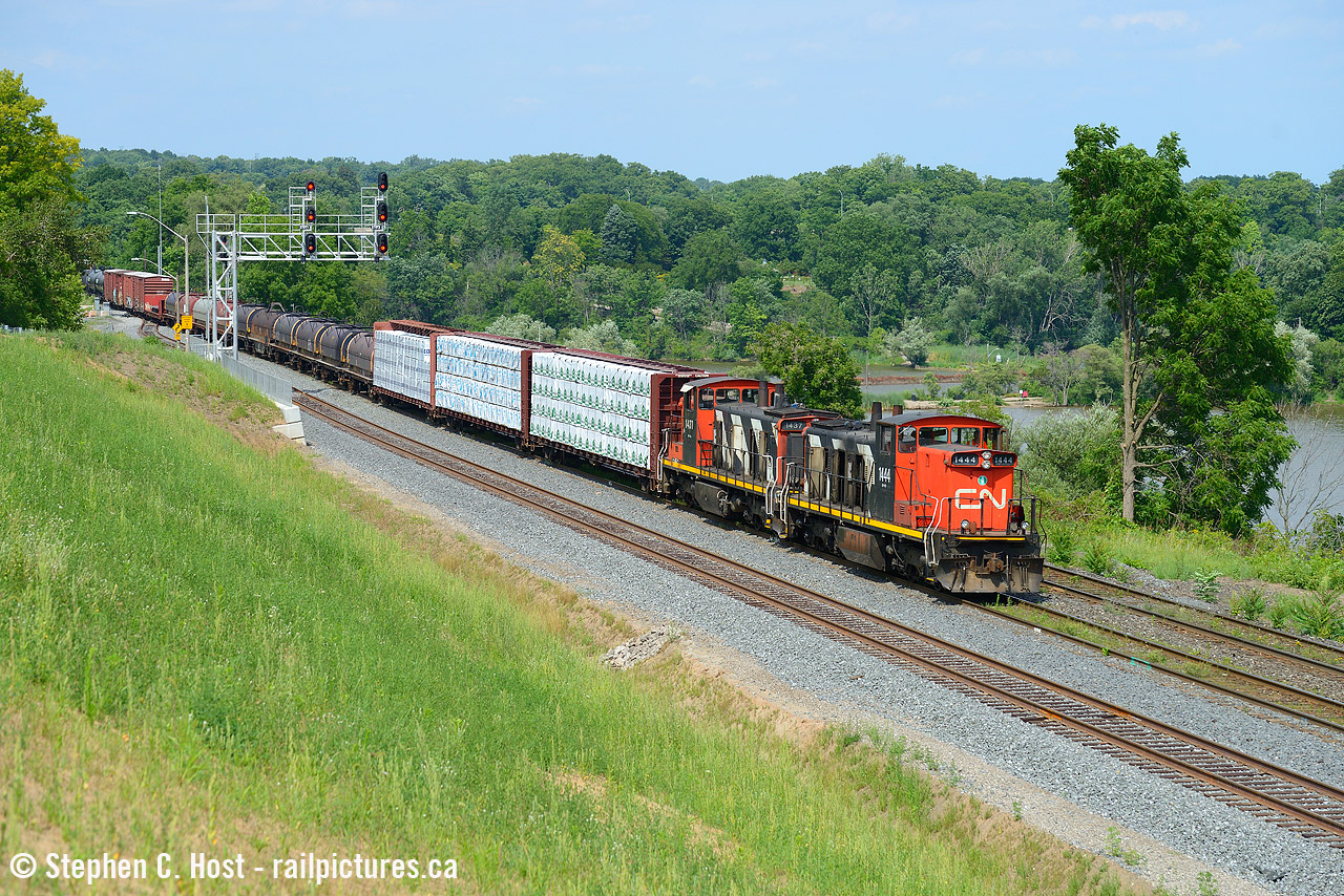 On a sweltering hot day the crew of L551 have all the doors open to ensure both man and machine do not overheat as they head into Hamilton with Michael DaCosta as conductor.
I posted about this hill in a prior photobut fans of Bayview from afar might not recognize this location - this is the 'new' hill I talked about that was created after the triple tracking project completed into Hamilton. This nice vantage point was basically a dirt mound for years as the project continued, but in 2020 was seeded to grass making it official. This is the result, while only a handful of freights pass this spot, it's going to be a nice spot to get Amtrak, VIA and GO in the future as well, so as long as it does not grow in too much (it will, eventually). There were three of us on the hill and I was the only one crazy enough to not have a cold beverage in hand, it was a hot hot hot day.
