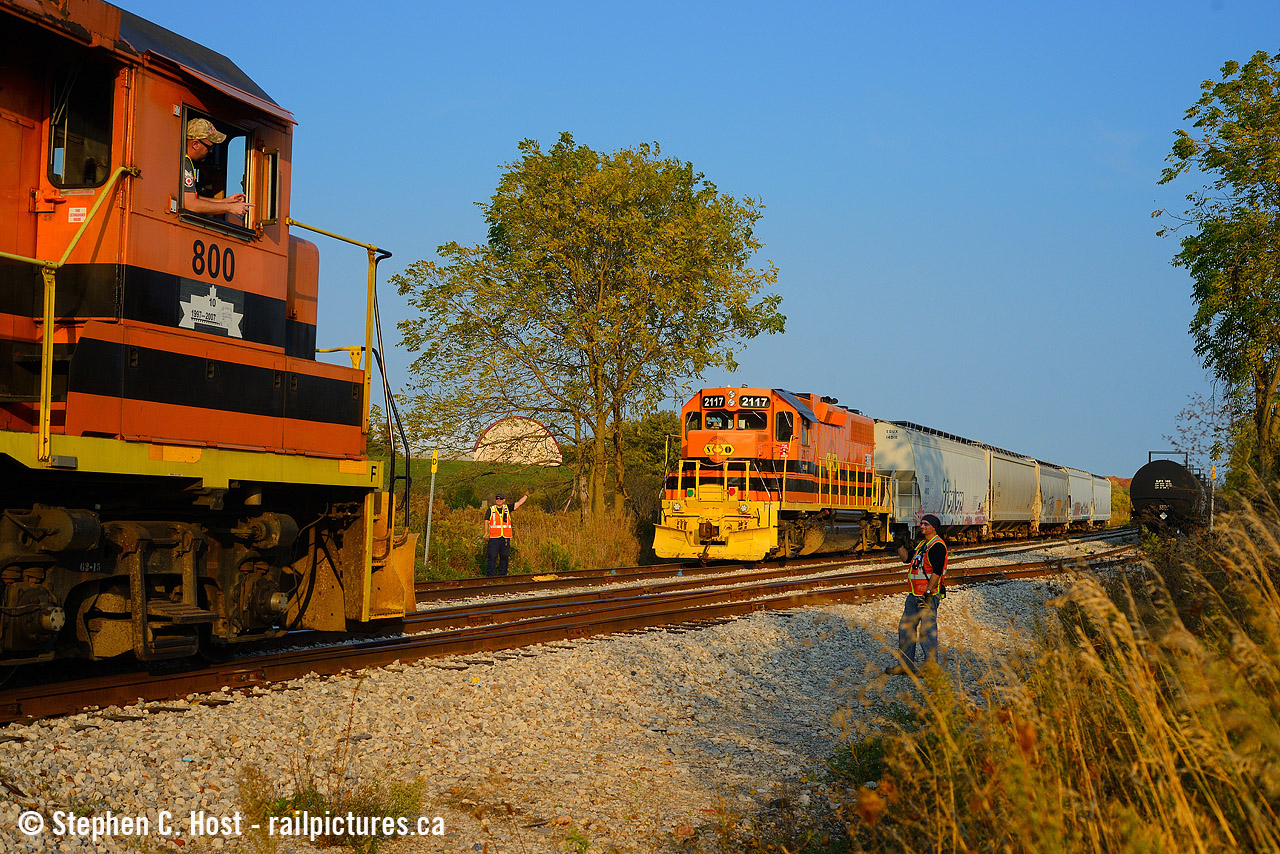 A meet in the countryside as two GEXR trains on the Guelph Junction Railway pass each other in Arkell, Ontario. Engr. Snook waves to his colleagues on 583 who have taken the siding and will perform an inspection for safety as 582 passes.