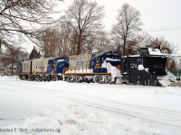This was one of the best trains I've ever chased (and the worst driving conditions I've ever been in). Just arriving at Cowie (now known as Stratford West), the crew has stopped to throw the switch for the mainline allowing me to soak it in, and I composed this scene. You can't even tell but that's the Guelph subdivision mainline in the foreground. It's my understanding the mainline was plowed by the 'other' plow either this day or the next (which would have been the orange plow at the time).<br><br>
Compare to <a href=http://www.railpictures.ca/?attachment_id=31860 target=_blank>this OSR image</a> as they are almost the same, but I really really prefer the matching Raillink schemes in this classic GEXR shot. What do you prefer for paint on the F units? Seeing that they have moved from GEXR to OSR and are still in the area. I suspect this will be a divisive question :)