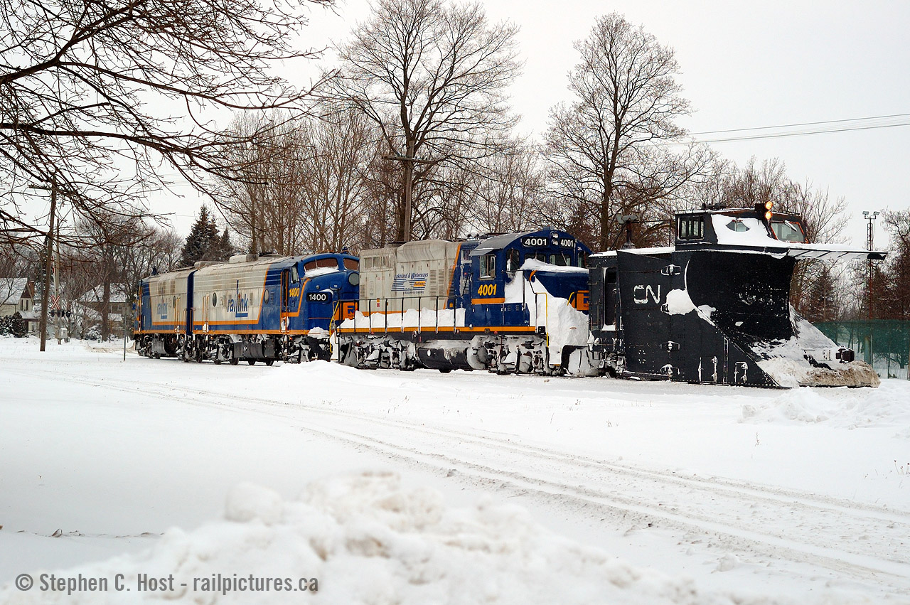 This was one of the best trains I've ever chased (and the worst driving conditions I've ever been in). Just arriving at Cowie (now known as Stratford West), the crew has stopped to throw the switch for the mainline allowing me to soak it in, and I composed this scene. You can't even tell but that's the Guelph subdivision mainline in the foreground. It's my understanding the mainline was plowed by the 'other' plow either this day or the next (which would have been the orange plow at the time).
Compare to this OSR image as they are almost the same, but I really really prefer the matching Raillink schemes in this classic GEXR shot. What do you prefer for paint on the F units? Seeing that they have moved from GEXR to OSR and are still in the area. I suspect this will be a divisive question :)