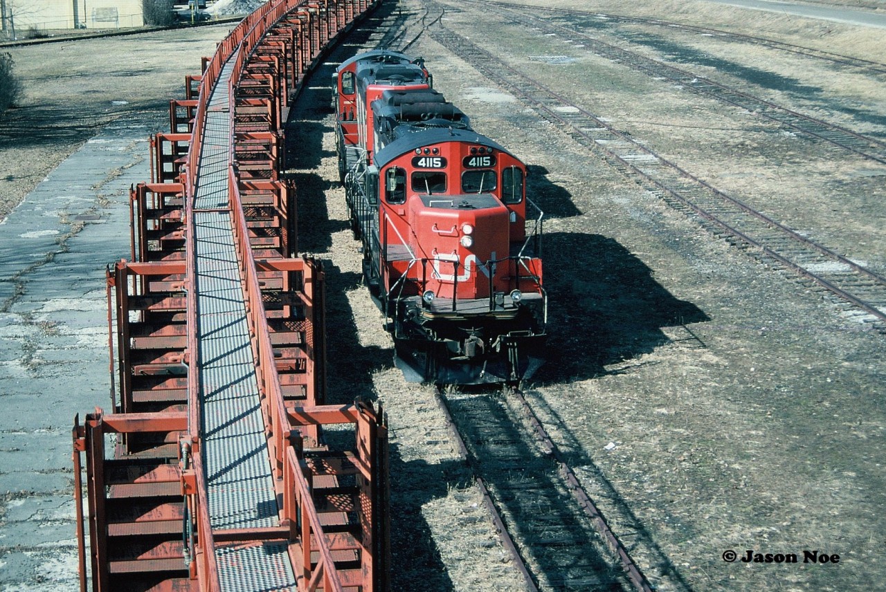 CN GP9RM’s 4115 and 4140 are seen running around their rail train from the town's historic Pedestrian Bridge that spanned the entire Palmerston yard. From here, once the run-around was complete the units would couple to the south end of the cars to await the final leg of their trip to Harriston. From Palmerston, they would shove the remaining five miles into Harriston on the Owen Sound Subdivision.