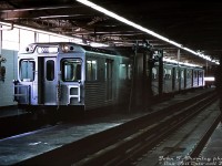 Brand new TTC H1 subway cars 5458 and 5459 make a demonstration run through the wash rack at Greenwood Yard car shops, during a tour of the new Greenwood Yard, shops and subway line a few days before official opening day on February 26th 1966. Interior wash racks were installed in the car shop building at Greenwood where cars are cleaned and inspected before service, in order to allow washing cars' exteriors during the winter to prevent things from freezing up. Warm air jets dry the car off after going through the wash rack, and interiors were cleaned by shop forces at the same time.
<br><br>
For the film enthusiasts, this was noted by John on the slide as shot at f4.0 at 1/50 of a second, on ASA 25 (!) Kodachrome slide film, underexposed by one stop, so the entire image was really, really dark. Even the scanner settings and some editing couldn't make any of the scans sufficiently bright, so the slide was illuminated by a bright light source and shot with a DSLR zoomed in very close, and edited from there.
<br><br>
<i>John F. Bromley photo, Dan Dell'Unto collection slide.</i>
<br><br>
More Greenwood: overhaul & repair shop: <a href=http://www.railpictures.ca/?attachment_id=32686><b>http://www.railpictures.ca/?attachment_id=32686</b></a><br><br>
New subway car being unloaded: <a href=http://www.railpictures.ca/?attachment_id=32686><b>http://www.railpictures.ca/?attachment_id=32686</b></a>


