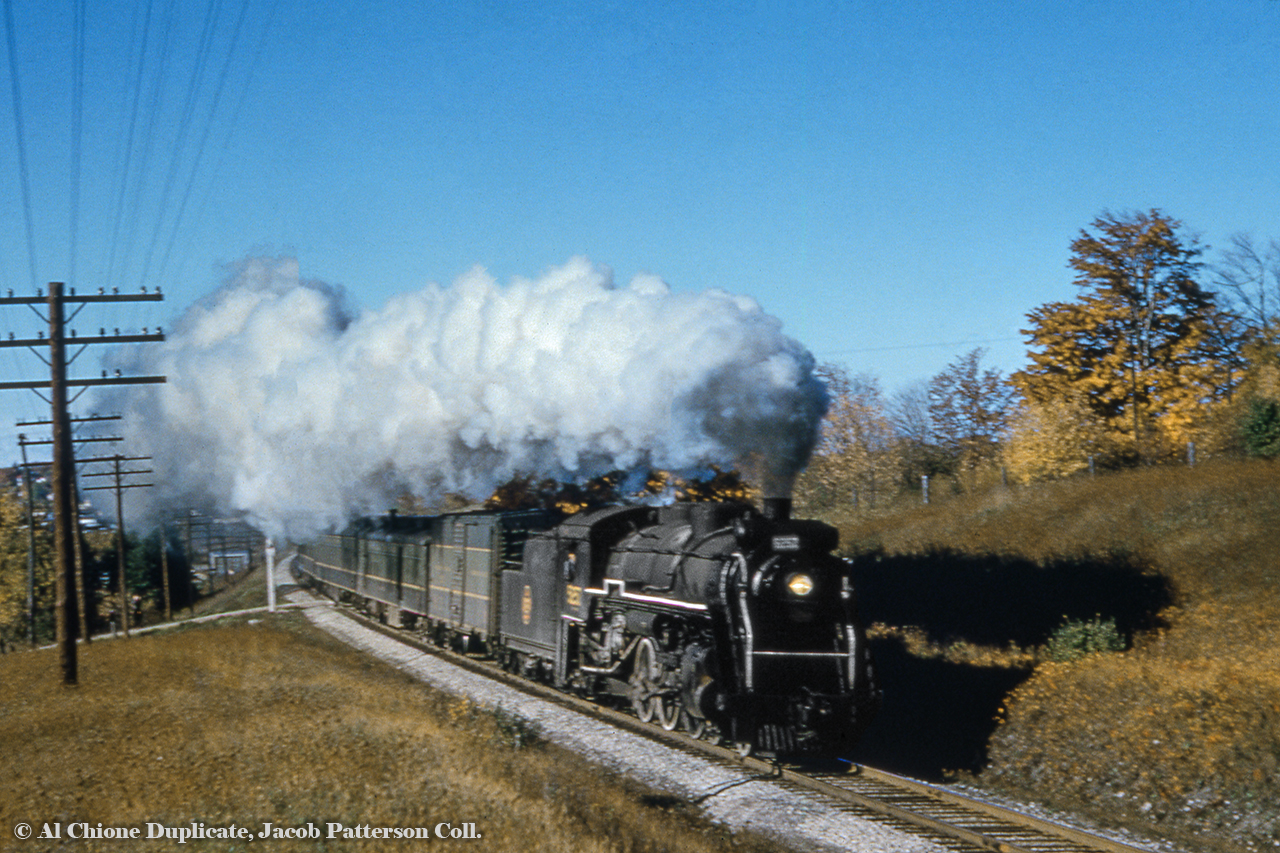 Cityview Drive Part 2 - Eastbound: Train 172 gets up to track speed departing Guelph at Cityview Drive, a crossing which would be closed in the early 2000s due to poor visibility coming through the curve.  Built by MLW in 1918 for the Canadian Government Railways as 485 and renumbered in 1919 to CNR 5257, the J-7-a would be scrapped in less than 6 months in March 1959.Part 1 - Westbound found here.Original Photographer Unknown, Jacob Patterson Collection.