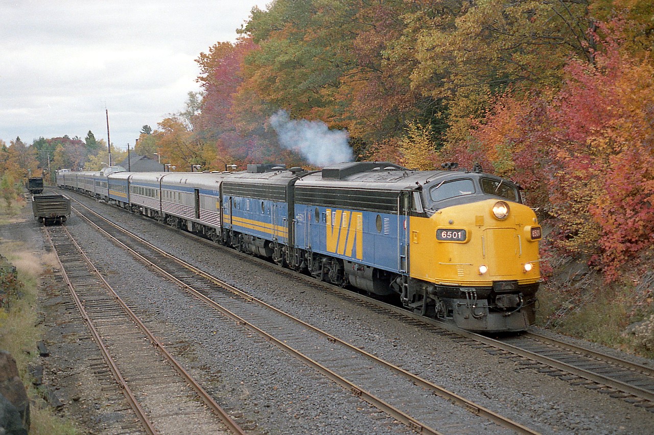 It is a personal 'thing', but as I post photos such as this I cannot believe they are 30+ years into the past already. This one 34 years coming up, and it feels like a mere 5 years distant. I'm wondering if some of the older photographers on this site feel the same way with their own works.
 
The Toronto portion of the Canadian, once a grand Lady, has rolled to a stop at Parry Sound in this photo taken from rocks where the track turns northward toward Sudbury.  Power is VIA 6501 and 6635. I assume 6501 has been scrapped.