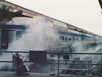 Typical Vancouver day! Lots of liquid sunshine! I had just heard that VIA Rail was selling little piggy banks and I wanted one so I braved Vancouver's slug like traffic, parked, walked across some wet grass and purchased one. After the big buy I walked out to the rear of the station & took the attached photograph which shows that VIA Rail train was still being heated by steam. As for the piggy bank I still have it along with it's original box. Some day one of my kids will open it and get rich. Of course I have no idea what 11 cents will be worth in the future. 