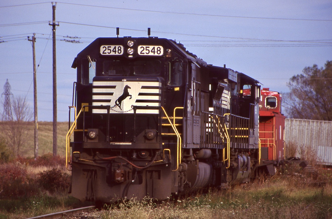 By the late 1990's Norfolk Southern's intermodal terminal in Dain City (near Welland) only had months left before closing. It was an interesting place, very compact as it was situated at the former Welland Junction, which vanished when the new Welland canal was built. The old main here was used to store NS power awaiting the next trip States side, as seen here with a SD70 and Dash-9. The NS caboose was a left over from when NS stopped using caboose on mainline trains in Canada, probably just months earlier. It wasn't long after CN turned the trackage here over to Trillium that NS pulled out as well. Today a translating facility is located here and all of NS' trains in Ontario are just a fading memory, with only a transfer job running between Buffalo and Fort Erie.