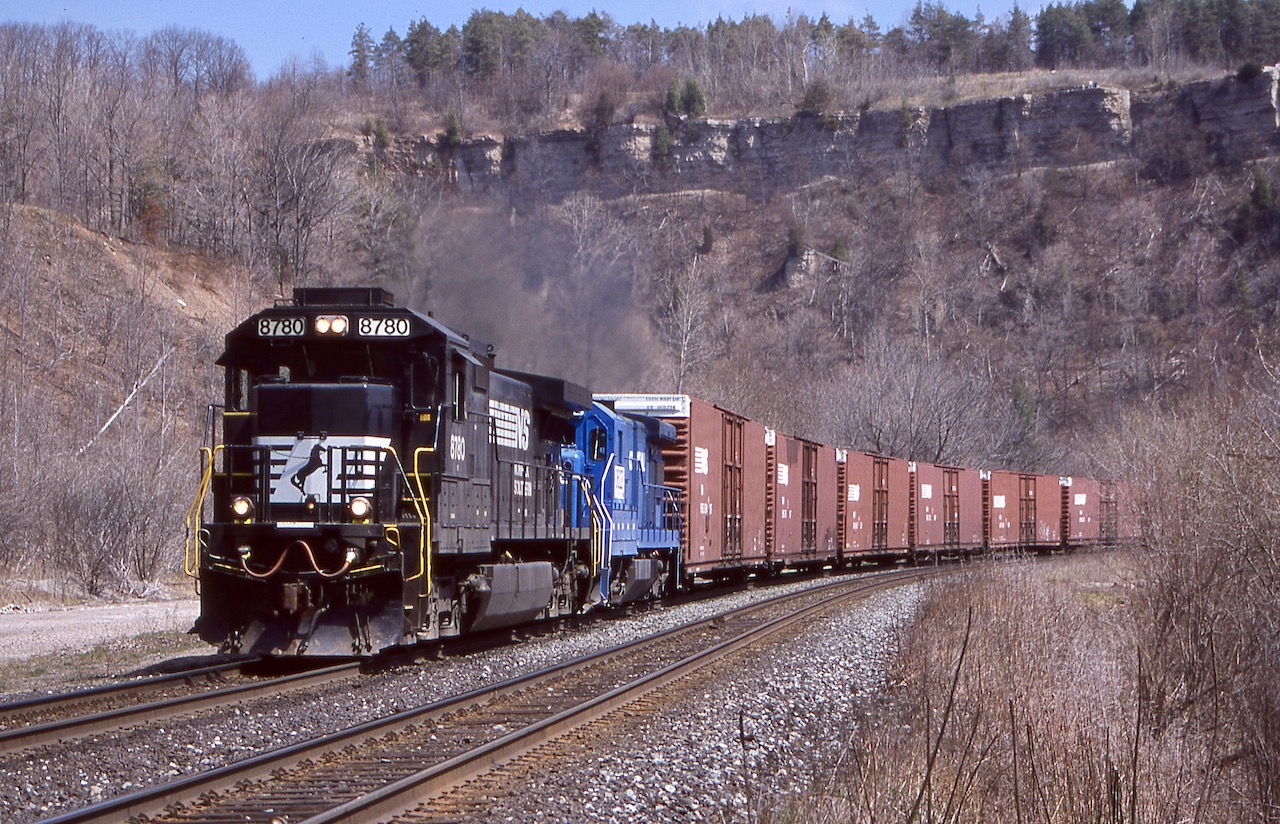 One of the very few times I caught the NS train in Dundas. Here NS 327 is digging into the Niagara Escarpment as it passes the old station site in town, while the Escarpment fills the background. It was nice catching a soon to be retired ex Conrail four axle Dash-7 trailing this day.