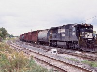 I love the old hunch back original Dash-8's, especially the former N&W ones with the plated out nose headlight housing. By this date the surviving ones had new nose grab irons installed and ditch lights on both ends, although the long hood was technically the front of the unit. Former N&W 8566 has just pulled off the Stamford sub. and was now in the process of backing into CN's now removed Niagara Falls yard. This move allowed the single unit to be nose forward later for the trip back to Buffalo. the track in the foreground served the now repurposed lumber yard behind me. Today both tracks in the foreground are removed leaving only one track, and NS only goes as far as Fort Erie today for its interchange.