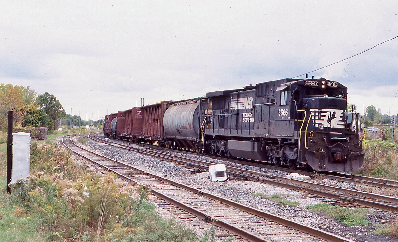 I love the old hunch back original Dash-8's, especially the former N&W ones with the plated out nose headlight housing. By this date the surviving ones had new nose grab irons installed and ditch lights on both ends, although the long hood was technically the front of the unit. Former N&W 8566 has just pulled off the Stamford sub. and was now in the process of backing into CN's now removed Niagara Falls yard. This move allowed the single unit to be nose forward later for the trip back to Buffalo. the track in the foreground served the now repurposed lumber yard behind me. Today both tracks in the foreground are removed leaving only one track, and NS only goes as far as Fort Erie today for its interchange.