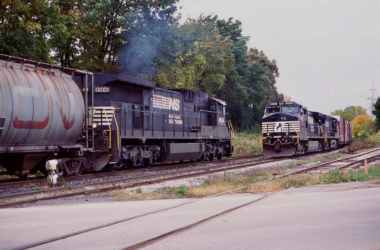 This day the stars aligned as it was the only time I caught two NS jobs on CN in Niagara. NS transfer job 445 out of Buffalo has just cleared the switch at Cliffton off the Stamford sub. and is beginning to back into CN Niagara Falls yard, while St. Thomas to Buffalo train 328 waits for it to clear and head onto Buffalo. By this time the NS C39-8's were nearing retirement.The 8566 started life as a N&W unit and was built to operated long hood forward.