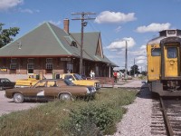 
<br>
<br>
   Awaiting the arrival of the crew for the 17:45 departure, the usual ubiquitous pair of ex CP Rail Budds is the equipment for Sunday only VIA Rail train #189
<br>
<br>
   at Havelock *,  August 4, 1986 Kodachrome by S.Danko. 
<br>
 <br>
<br>
   Interesting: Havelock Budd's canceled September 6, 1982; restored June 3, 1985, canceled January 14, 1990.
<br>
<br>
   *  Station construction by CPR commenced 1914, interrupted by WWI, completed 1929. 
<br>
<br>
   Completed in August 1884 the Ontario & Quebec Railway (Perth to North Toronto) subsequently signed a lease agreement that expires in 2883.
<br>
<br>
   The 999 year leases allows the CPR absolute and complete control of the O & Q assets confirmed per a 1980 era court ruling as a result of legal action by some minority O & Q shareholders.
<br>
<br>
   The lease agreement, along with other lease agreements with the Toronto Grey & Bruce, Credit Valley Railway and  the West Ontario Pacific Railway (WORP) (leased to the O & Q in 1883), which connected the Credit Valley in Woodstock to Windsor and the US border, formed major components of the CPR network in southern Ontario.
<br>
<br>
   The January 14, 1990 cessation of Havelock Sub passenger service, CP Rail issued a new employee time table,  the following station names [were] removed from the Havelock Subdivision: Indian River; Manvers, Burketon, Dagma, Locust Hill, and Tapscott. (per UCRS Newsletter February 1990). And the Havelock Sub speed limit reduced to a maximum 30 m.p.h.
<br>
<br>
   And the vehicles: all American iron: at left the ever popular Oldsmobile Cutlass sedan ( likely a GM Canada Oshawa build) , Chevy pickup, GMC Pick up, and a brown Chrysler Newport sedan. 
<br>
<br>
<br>
     <a href="http://www.railpictures.ca/?attachment_id=  7752"> at Peterboro </a>
<br>
<br>
    sdfourty
