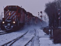 <br>
<br>
   Yep, it was cold and dark ( image just a wee bit brightened ) ....and for Leaside: this is snowy.
<br>
<br>
   Extra 5738 west with SD40 #5508 and a TH&B switcher in tow (note white flags, corresponding illuminated marker lights).
<br>
<br>
   The absolute tri signal at right governs eastbound traffic from the Don Branch of the Belleville Subdivision
<br>
<br>
   At that time, for a long time, Leaside had only a single crossover from south track to north track, to allow eastbound Don Branch traffic ( used by the Havelock Budds) to access the north track, hence only the double absolute signal required for eastbound north track traffic.
<br>
<br>
   At CP Rail Belleville Sub mile 206.4, December 22, 1979, Kodachrome by S.Danko
<br>
<br>
     <a href="http://www.railpictures.ca/?attachment_id=  45162">  westbound looking west  </a>
<br>
<br>