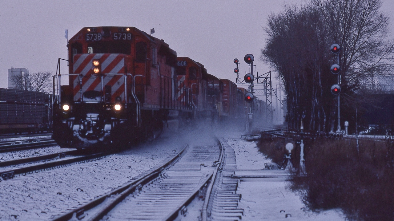 Yep, it was cold and dark ( image just a wee bit brightened ) ....and for Leaside: this is snowy.


   Extra 5738 west with SD40 #5508 and a TH&B switcher in tow (note white flags, corresponding illuminated marker lights).


   The absolute tri signal at right governs eastbound traffic from the Don Branch of the Belleville Subdivision


   At that time, for a long time, Leaside had only a single crossover from south track to north track, to allow eastbound Don Branch traffic ( used by the Havelock Budds) to access the north track, hence only the double absolute signal required for eastbound north track traffic.


   At CP Rail Belleville Sub mile 206.4, December 22, 1979, Kodachrome by S.Danko


       westbound looking west
