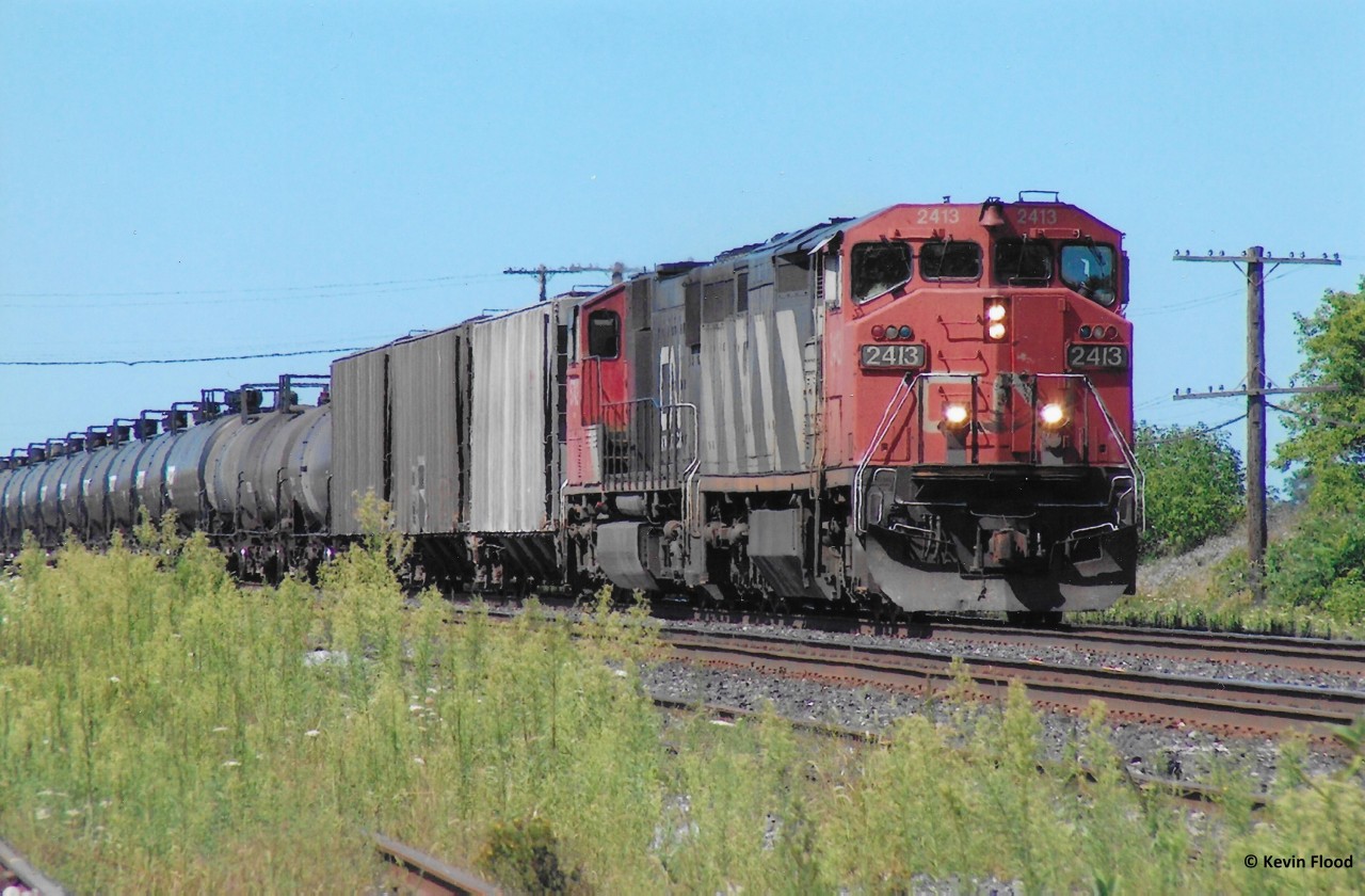 A CN eastbound led by CN 2413 is pictured rolling through Paris Jct. in August, 2006.