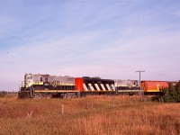 When CN took over Northern Alberta Railways on 1981-01-01, change thankfully came slowly to start, with locomotives renumbered into the CN pattern but Northern Alberta markings and locomotive names left intact, as on CN 4611 (ex NAR 210) and CN 4610 (ex NAR 209) bracketing B-unit 9192 as a westward train approaches Sexsmith on Tuesday 1981-09-15 heading for Grande Prairie.  The black-paint background for the cab-side number was later applied over the NAR diamonds and hood-side lettering, too, and that really hurt.
