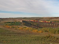 CN Q 10651 20: CN 3052, CN 8861, CN 3862 running DP 1x1x1 soars over the Battle River at Fabyan, Alberta with 163 loads for Montreal.