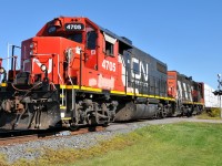 CN 4705, and CN 4125 have 21 cars on the drawbar. As they set a blistering pace of 10 miles per hour due to heat restrictions on the Hagersville Sub between 1430 and 1700