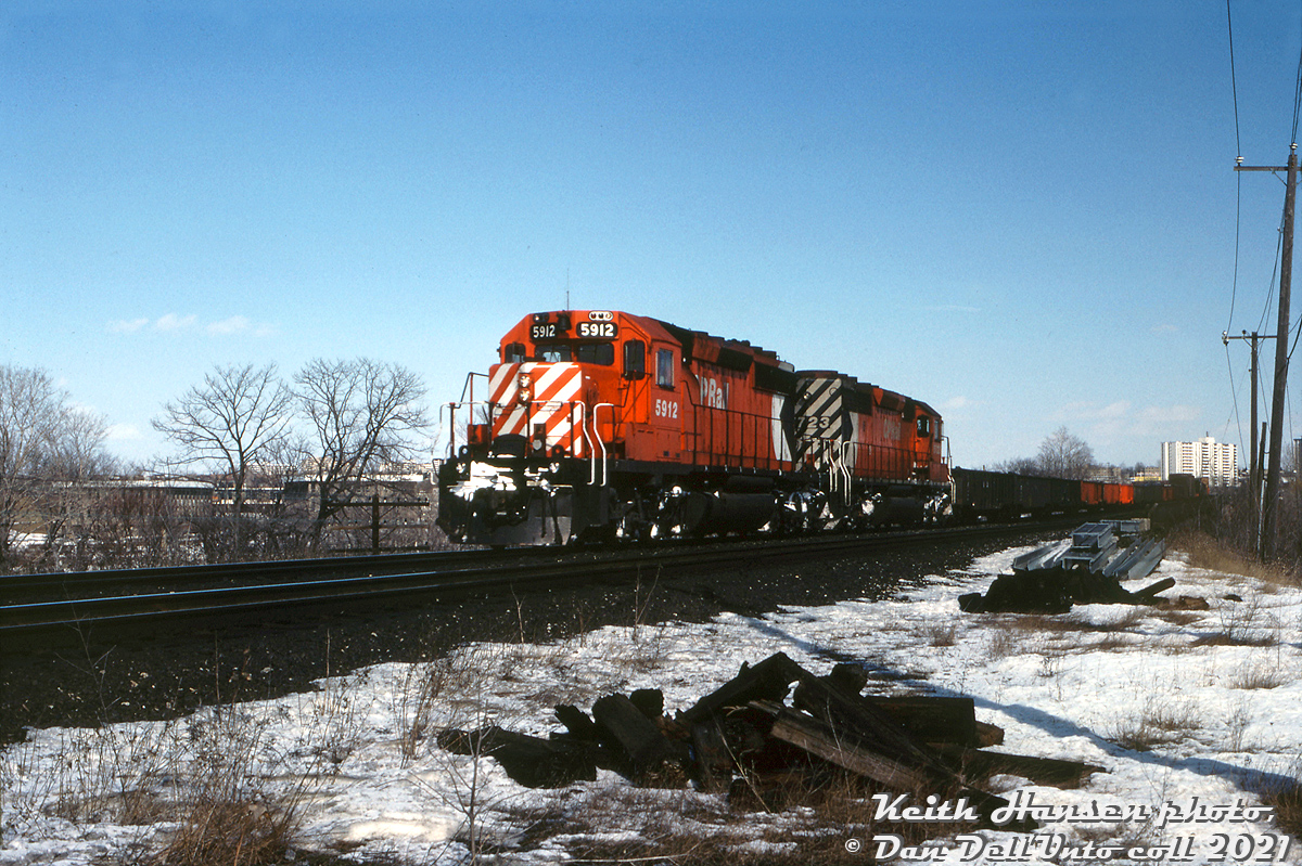 CP SD40-2 units 5912 and 5723, two of CP's fleet of hundreds of SD40-2 units that GMD London had been churning out for CP since 1972, head a westbound freight near Don Mills, seen here at Mile 203.4 of the Belleville Sub after crossing the trestle over CN's Bala Sub and about to cross over the Don Valley Parkway bridge. Apparently there were some CP detours down the CN Bala Sub on this date, but this doesn't appear to have been one of them.  Keith Hansen photo, Dan Dell'Unto collection slide.