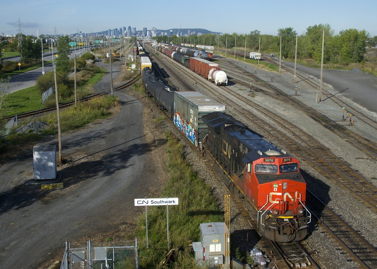 CN 322 is passing the CN Southwark sign as it back up part of its train onto the South Service Track. In the distance at left is another portion of CN 322 and its DPU. At right CN 522 puts its train together.
