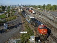CN 322 is passing the CN Southwark sign as it back up part of its train onto the South Service Track. In the distance at left is another portion of CN 322 and its DPU. At right CN 522 puts its train together.