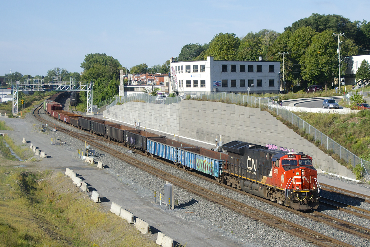 After setting off cars in Taschereau Yard, CN 322 is heading to Southwark Yard with CN 3180, 70 cars and CN 3916 on the tail end.
