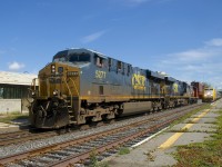 A short CN 327 with CSXT 5277, CSXT 5277 and CN 4721 for power temporarily passes a stopped VIA 35 at Dorval Station. CN 327 will have to stop just further ahead to let VIA 35 and CN 149 pass before it departs.