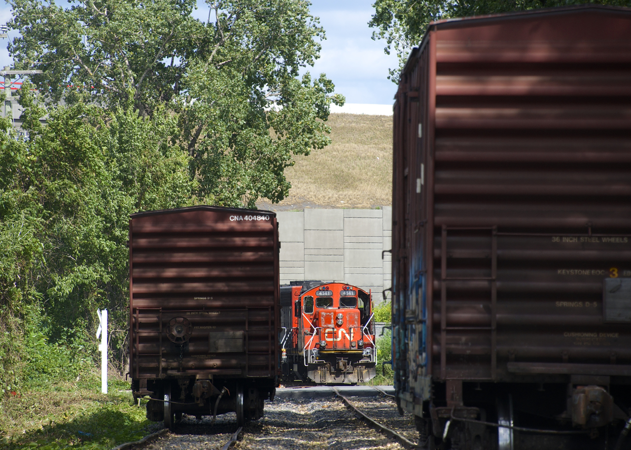 After leaving an empty on the siding (at left), CN 4141 gets ready to shove a load (at right) towards Kruger.