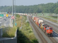 CN 120 has four units up front (CN 3809, CN 8890, CN 3932 & CN 2687) as it heads east past a large signal gantry on a portion of CN's Montreal Sub that is only a few years old.